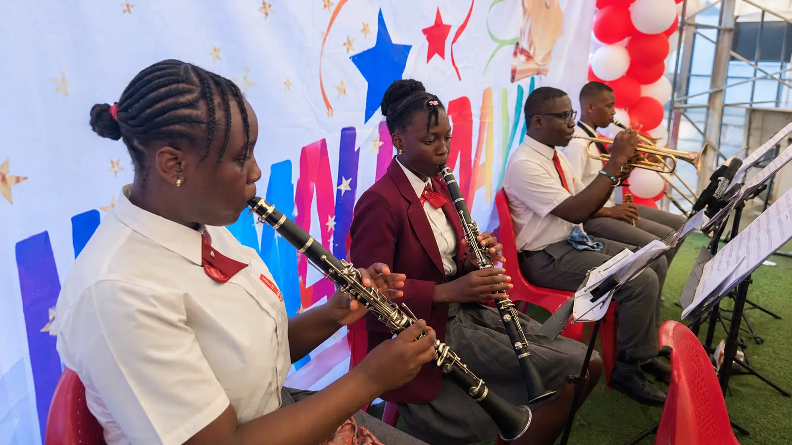 Petra Academy students performing with clarinets and brass instruments